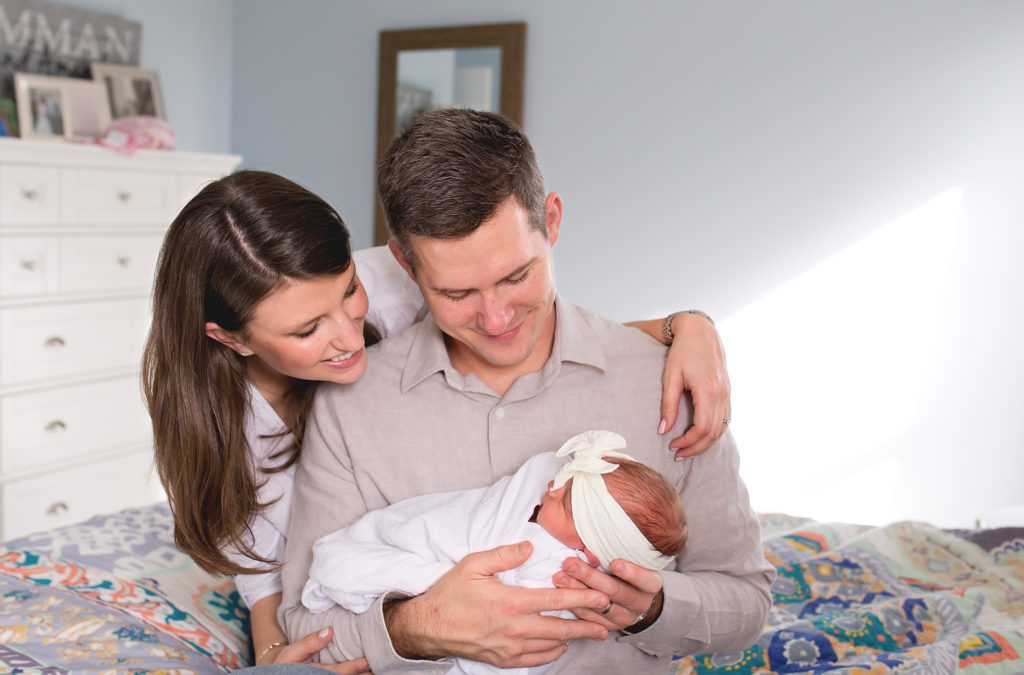 columbus ohio newborn lifestyle parents looking down at baby facebook
