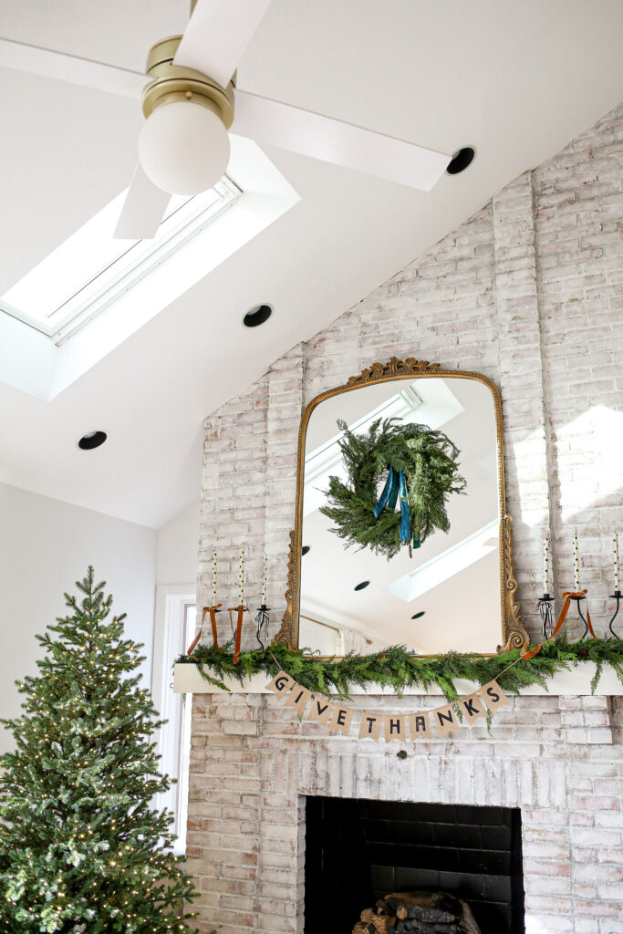 white washed fireplace with holiday decorations