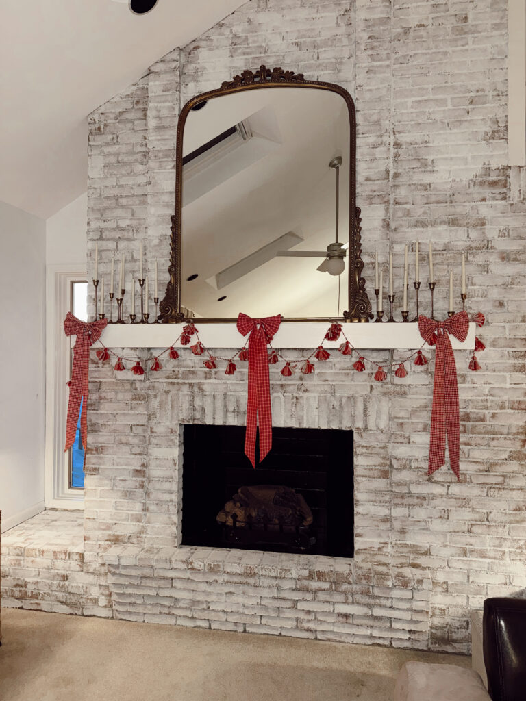 fireplace mantel decorated with bows and garland for valentine's day